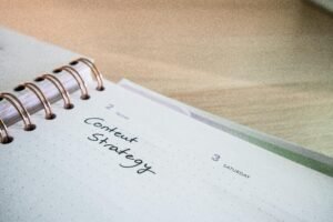 Close-up of a notebook page with 'Content Strategy' written on it, ideal for business planning visuals.